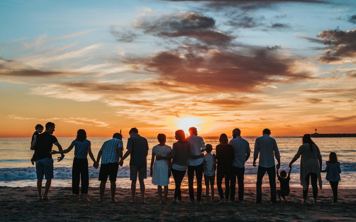 people standing on shore during golden hour by Tyler Nix courtesy of Unsplash.