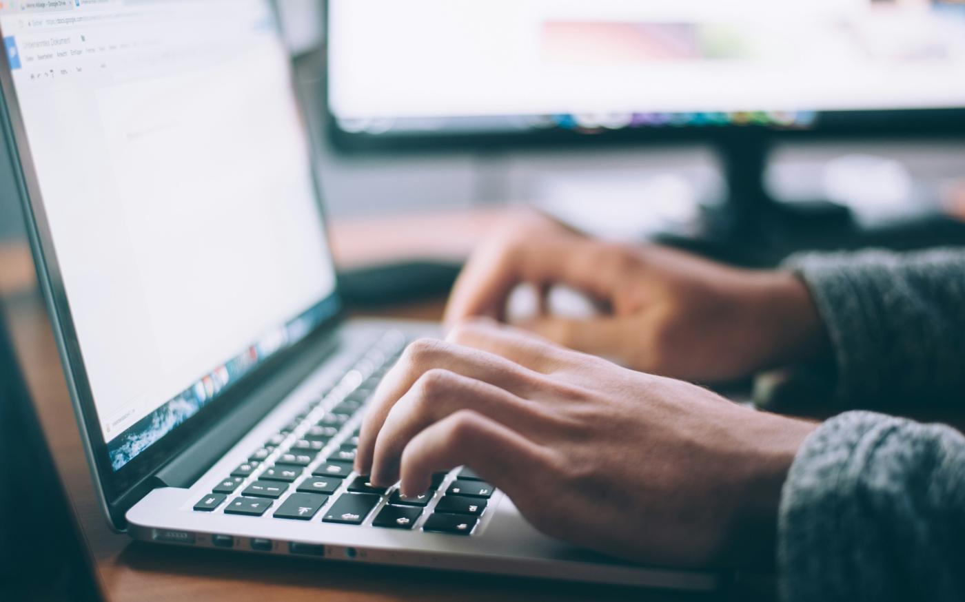 person using MacBook Pro by Glenn Carstens-Peters courtesy of Unsplash.